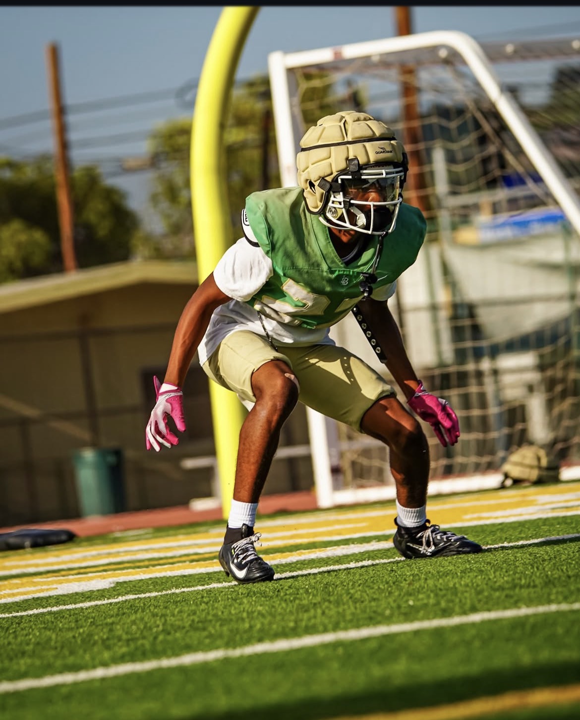 Ezra Rane Woodard in coverage stance during football practice